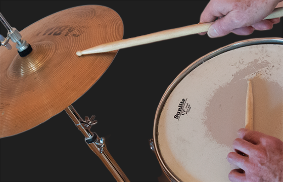 High-hat-and-Snare-A A person playing drums with a wooden stick