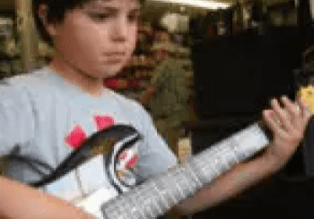 A young boy playing an electric guitar.